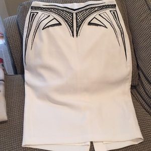 Bebe cream skirt with black beaded pattern.